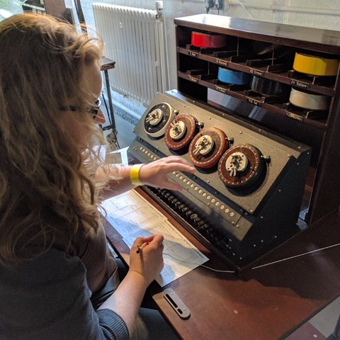 Kirstie decoding messages at an old machine